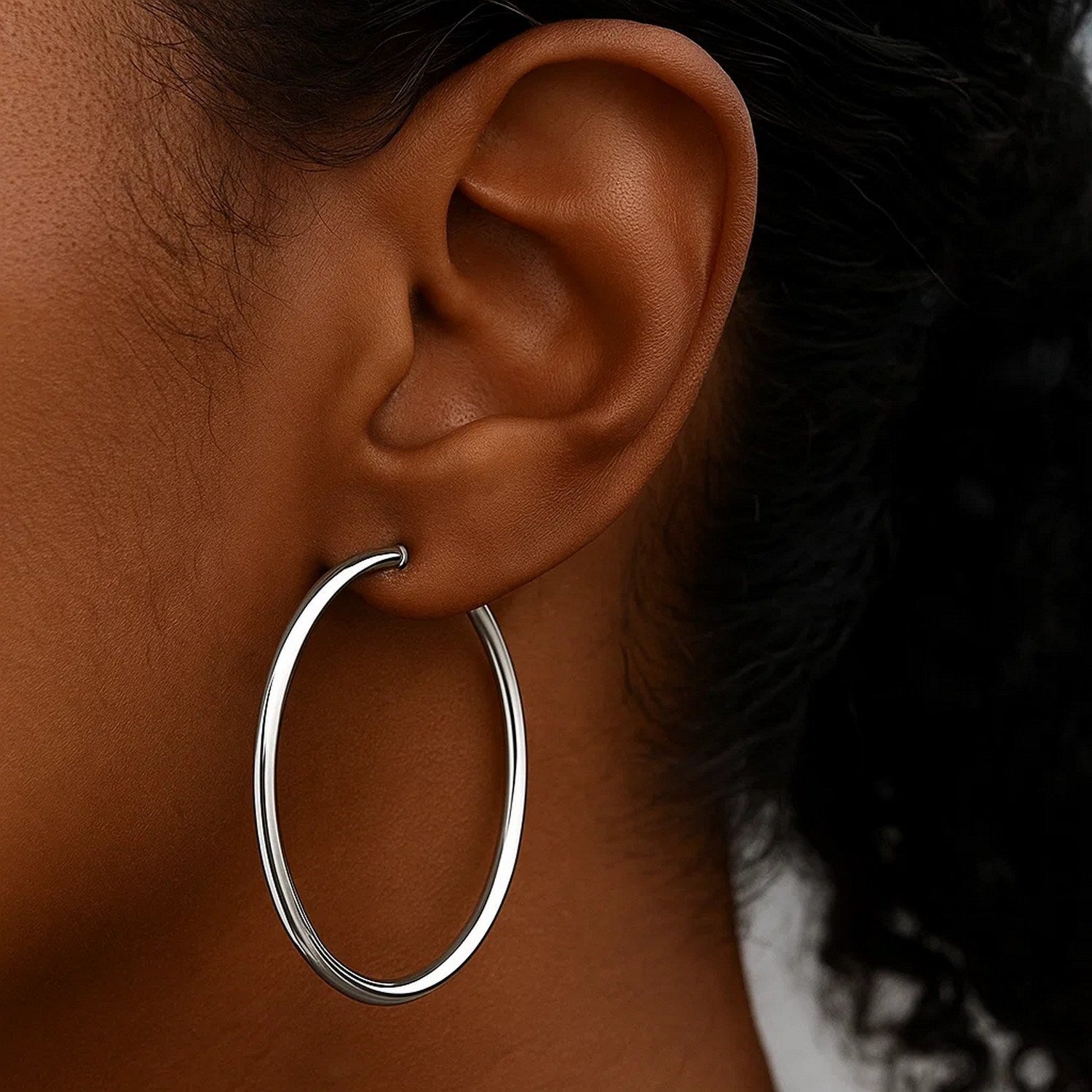 Polished 10k white gold hoop earrings crafted in 14k gold, showcasing a modern design with elegant shine.