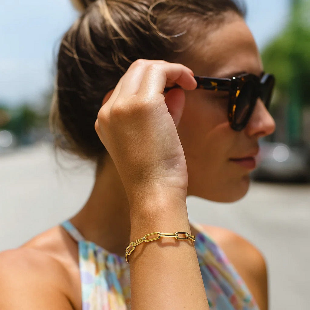 14k yellow gold bold paperclip chain bracelet featuring modern design and luxurious shine, perfect for elegant styling.