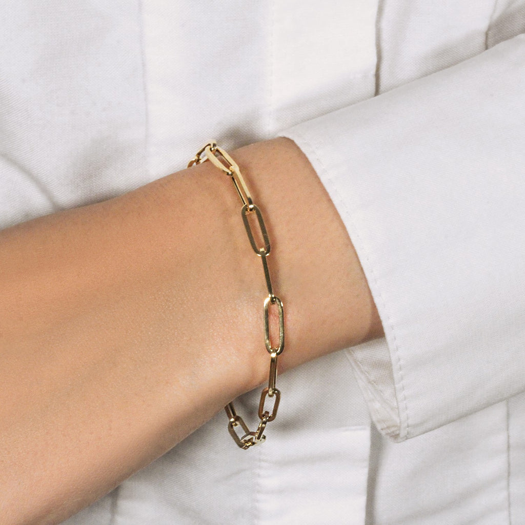 14K yellow gold bold paperclip chain bracelet featuring modern design and sleek round links, perfect for luxury styling.