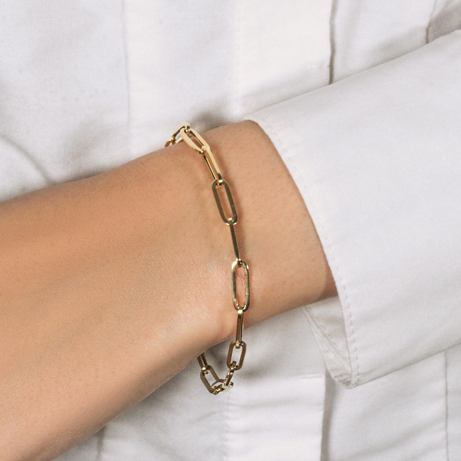14K yellow gold bold paperclip chain bracelet featuring modern design and sleek round links, perfect for luxury styling.