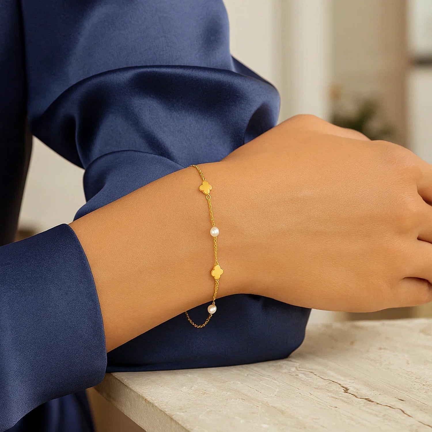 14k yellow gold minimalist bracelet featuring a delicate pearl clover link design for elegant sophistication.