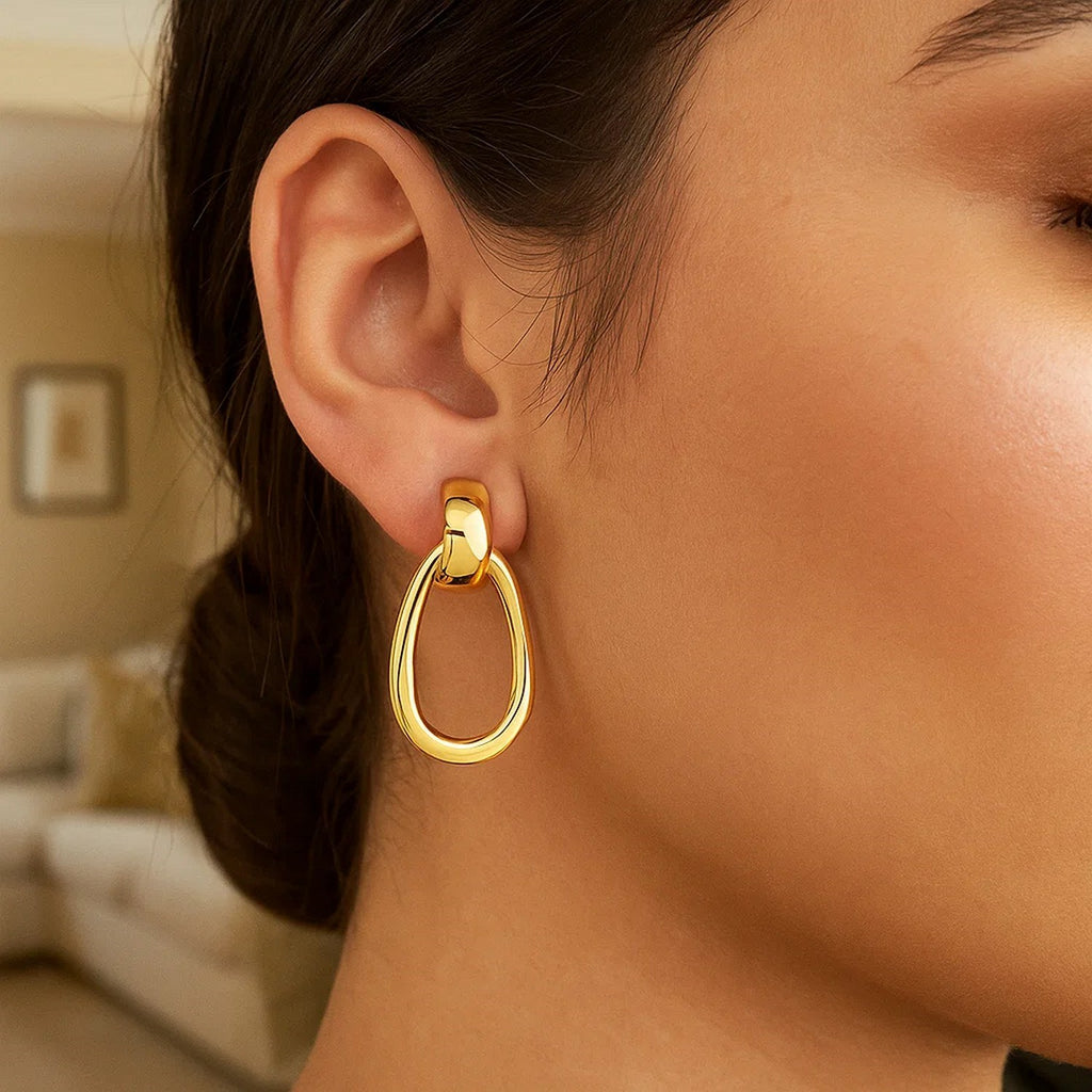 14k yellow gold polished hoop drop earrings with a modern design, showcasing elegance and timeless sophistication.