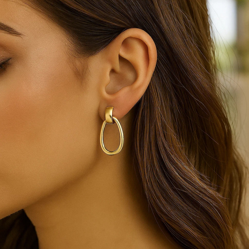 14k yellow gold polished hoop drop earrings with a modern design, showcasing elegance and timeless sophistication.
