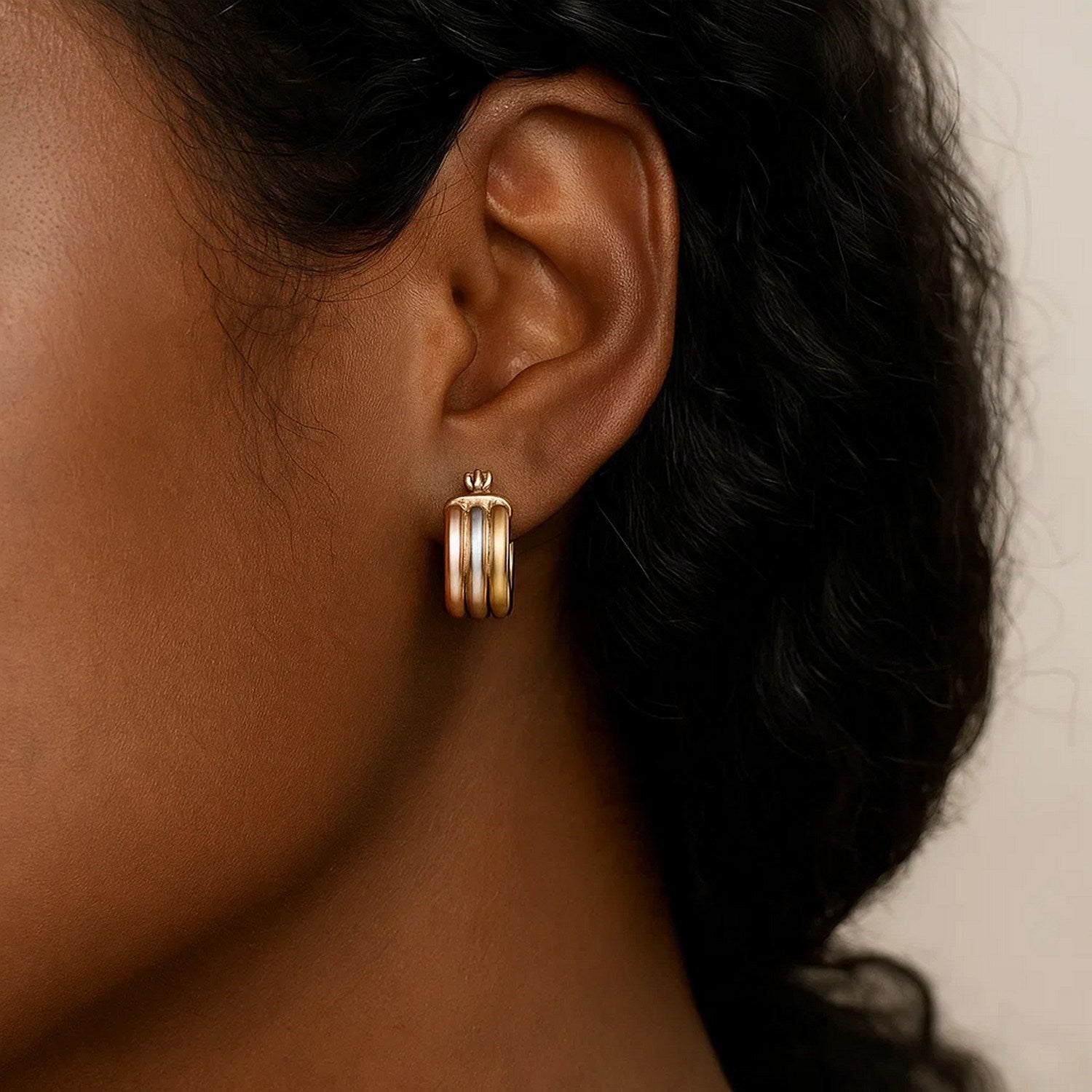 14k tri-color gold textured hoop earrings featuring a modern design, perfect for elegant occasions.