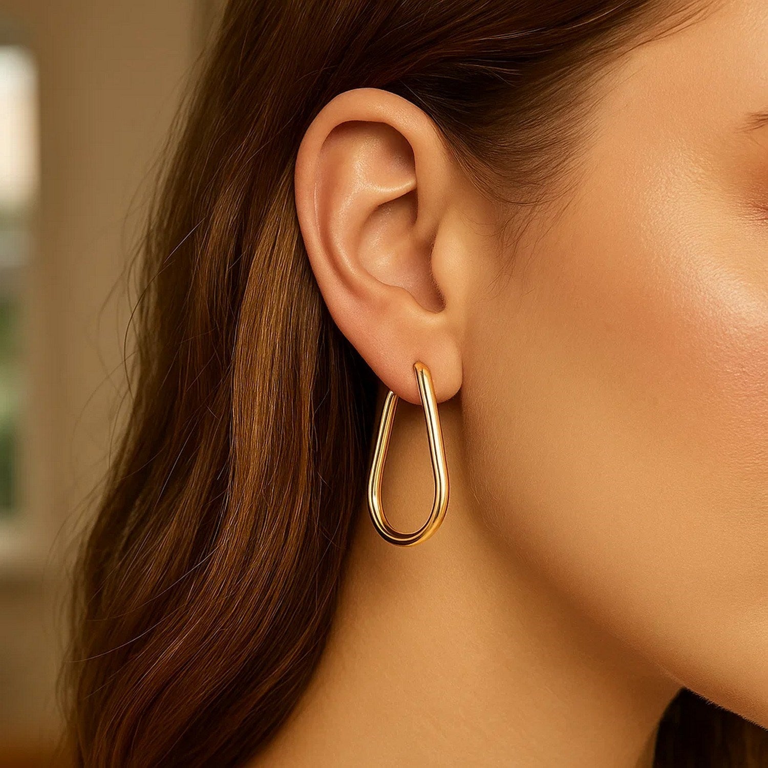 Elegant 14k yellow gold endless pear hoop earrings showcasing a refined design for sophisticated style.