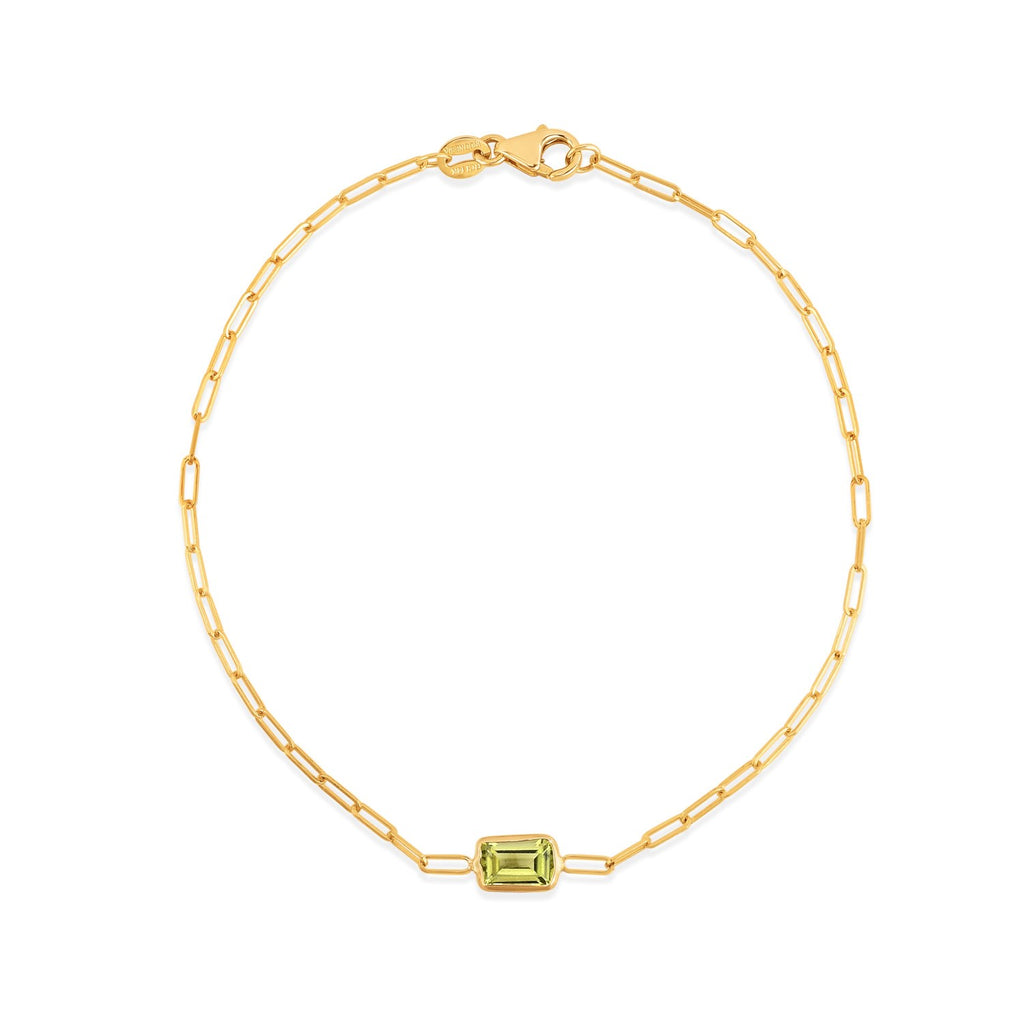 14k yellow gold minimalist paperclip bracelet featuring a bezel-set peridot, elegant and refined design.