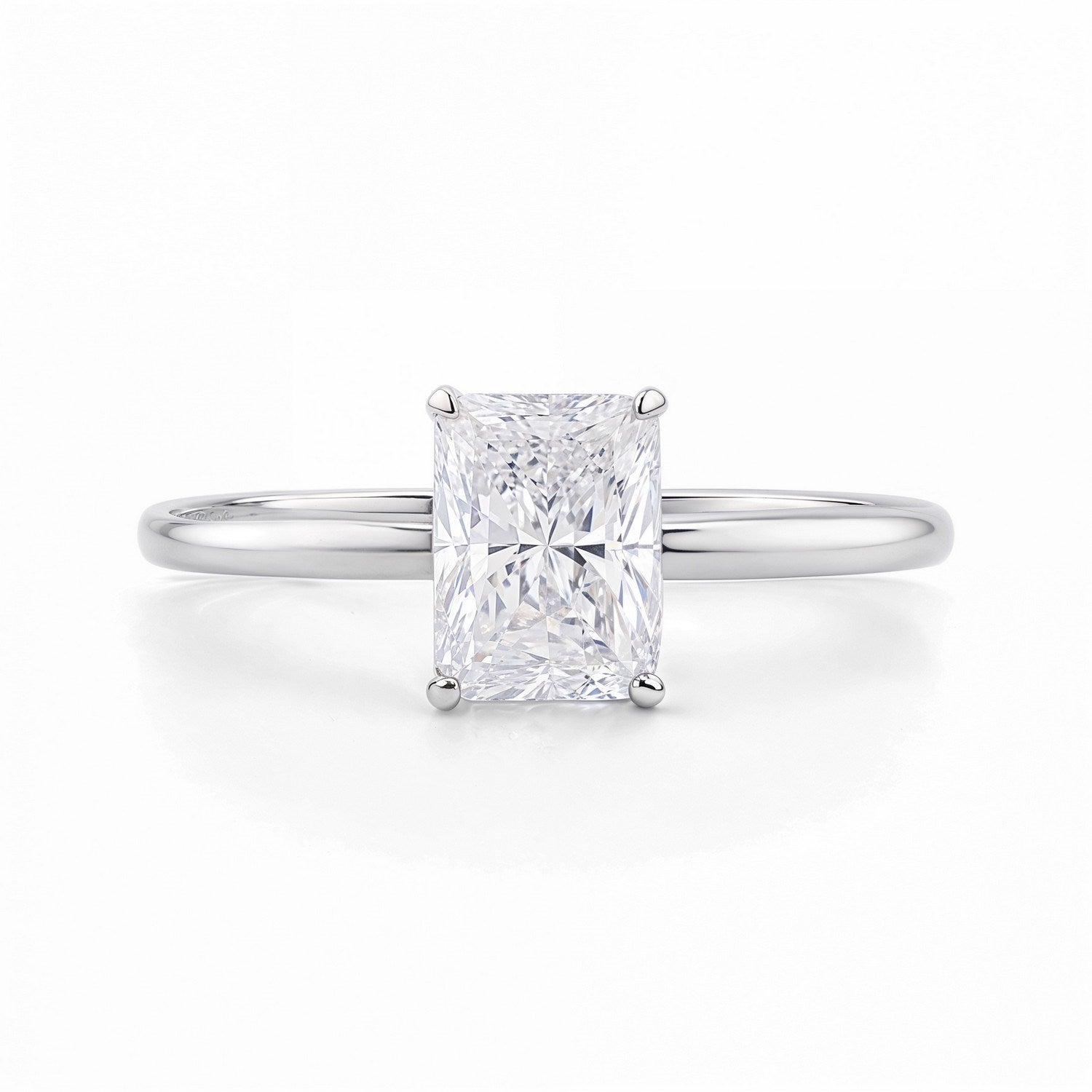 1 1/2 carat radiant lab-grown diamond solitaire ring in 14k white gold, featuring a modern prong setting.