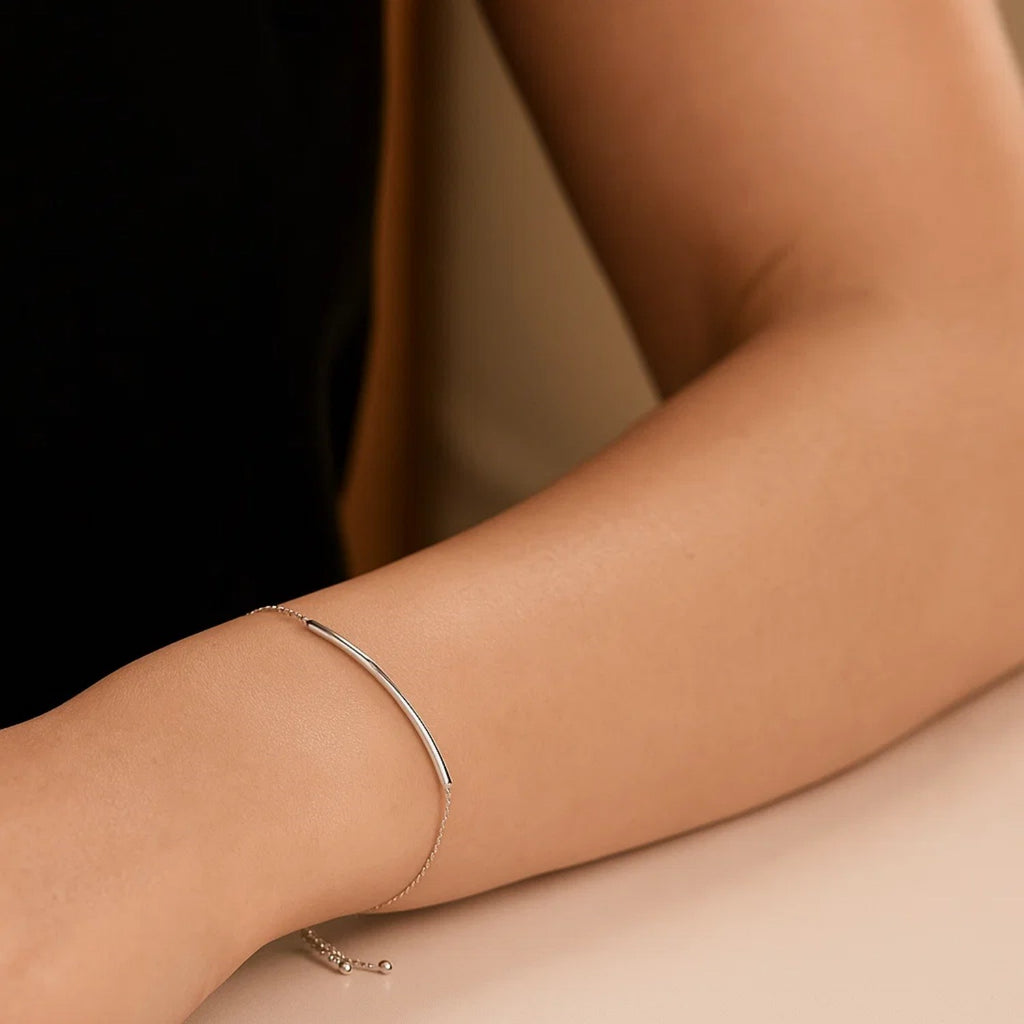14k white gold minimalist curved bar lariat bracelet with sleek chain design, perfect for elegant layering.