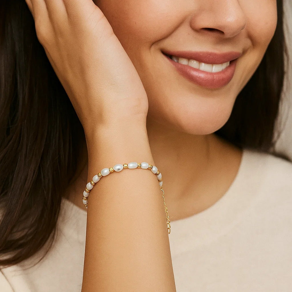 Elegant 14k yellow gold bracelet featuring faceted beads and lustrous freshwater pearls for a luxurious touch.