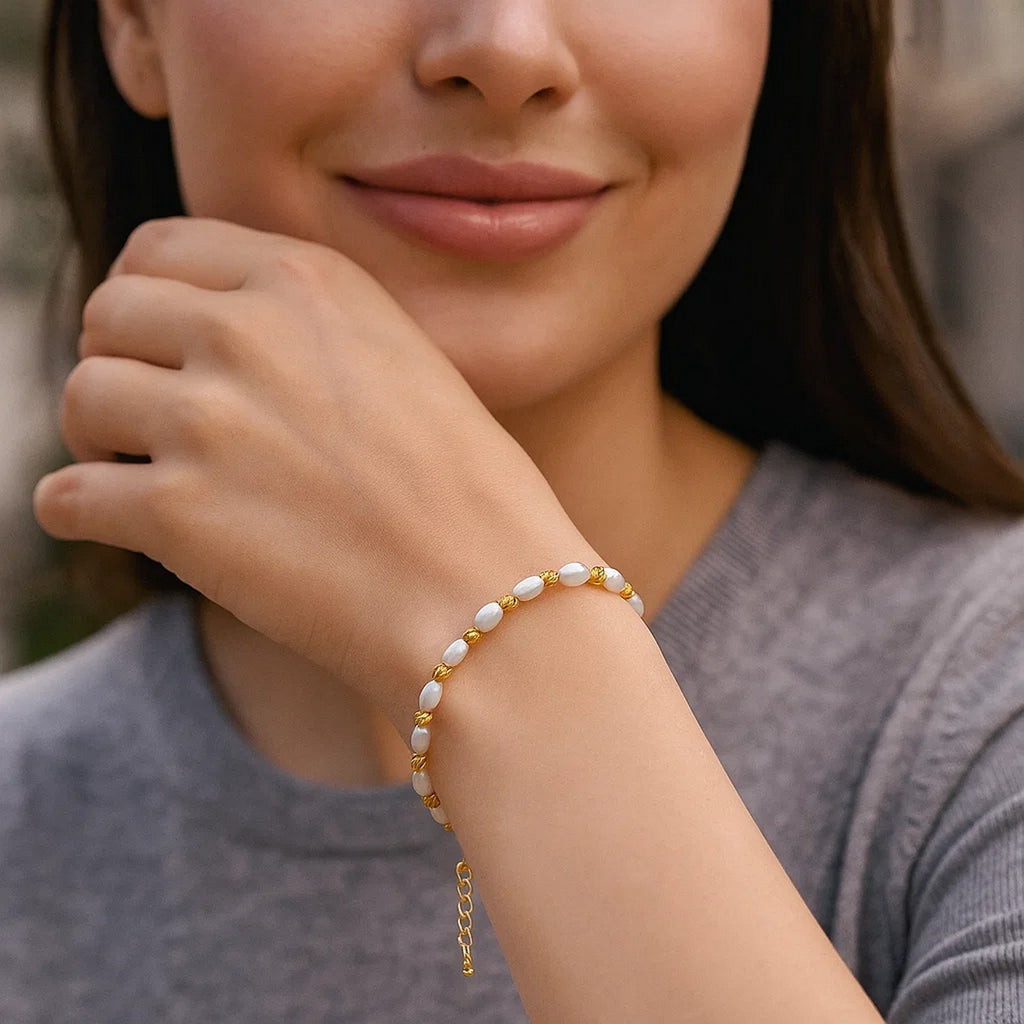 14K yellow gold faceted bead bracelet adorned with elegant freshwater pearls for a luxurious touch.