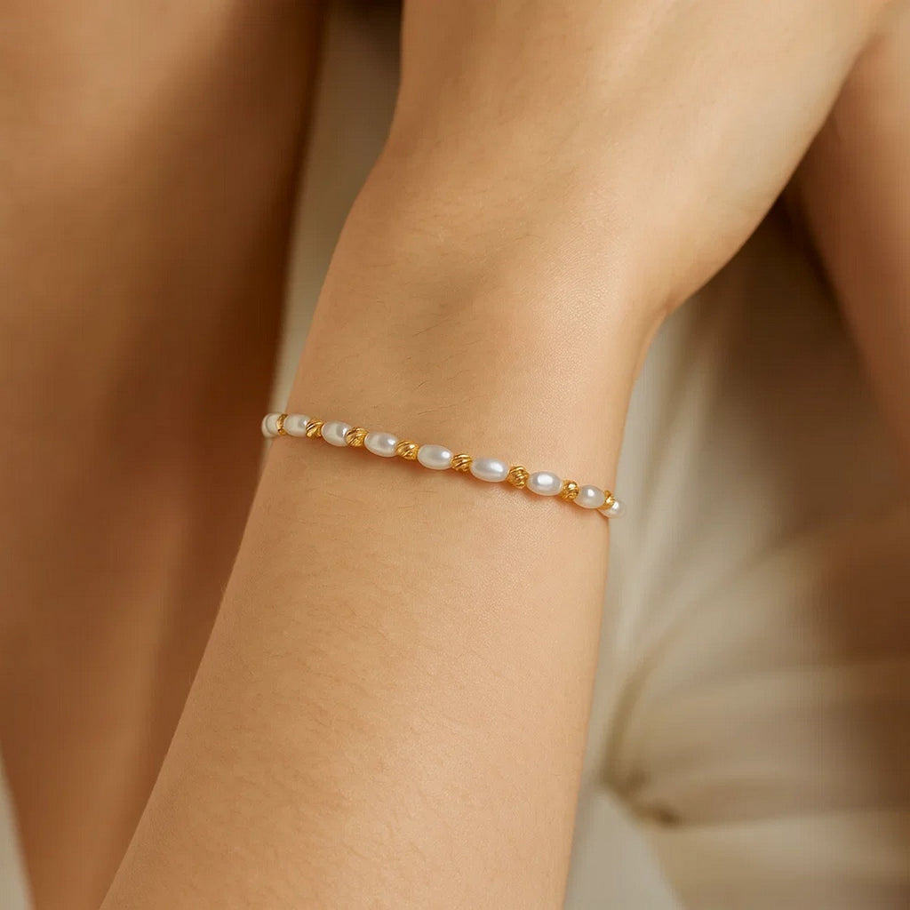 14K yellow gold faceted bead bracelet adorned with elegant freshwater pearls, showcasing luxury craftsmanship.