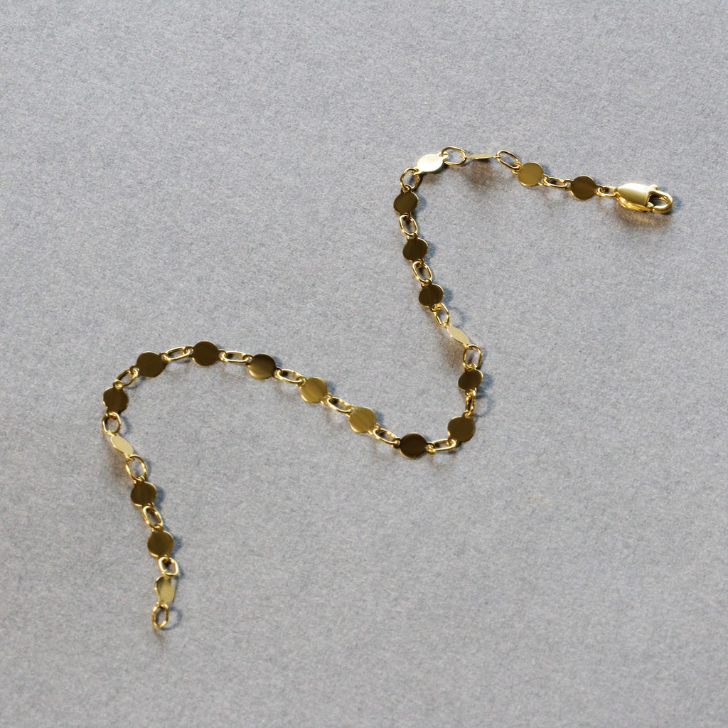 14k yellow gold modern bracelet featuring polished circles and elegant link chain design.
