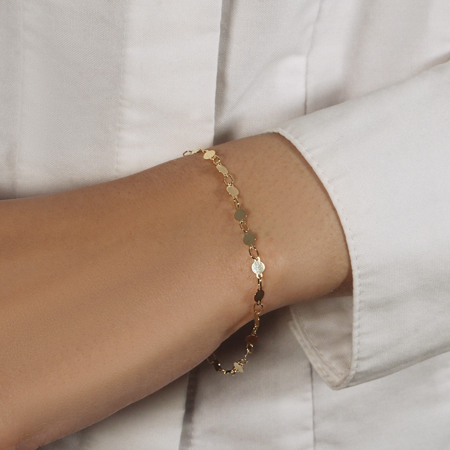 14k yellow gold bracelet featuring polished circles and modern link design, perfect for elegant layering.