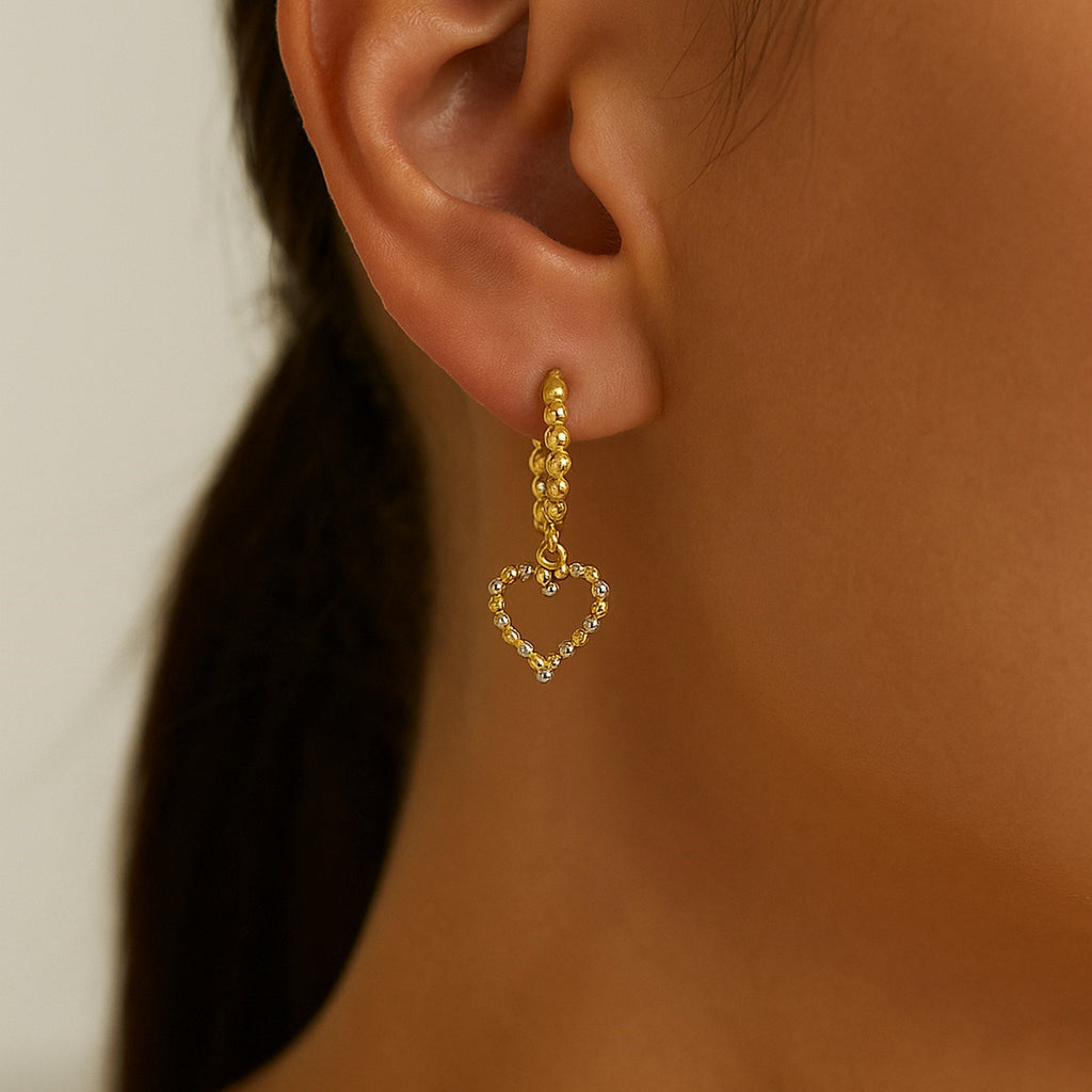14k two-tone gold textured beaded hoop earrings with a modern design, perfect for elegant occasions.