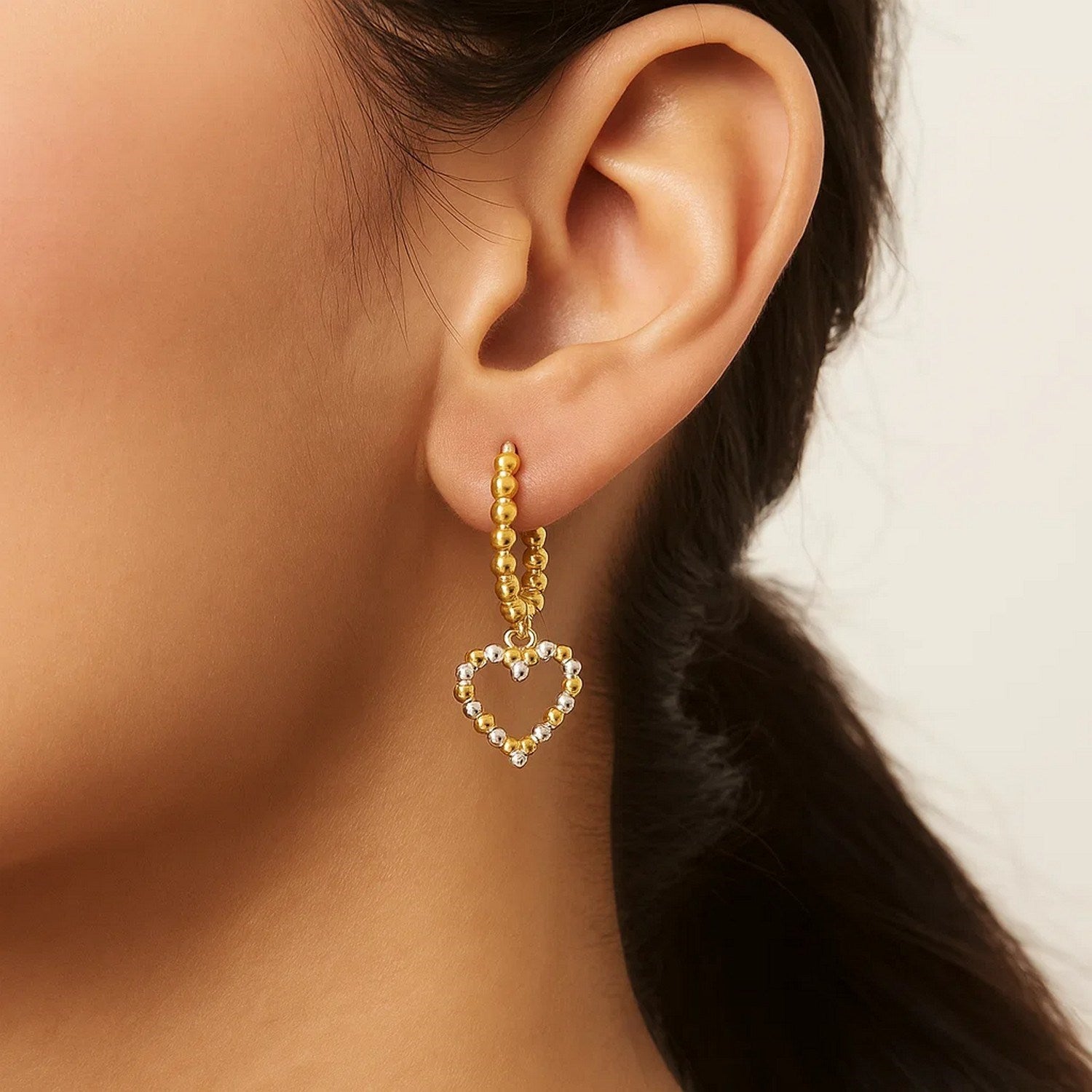 14k two-tone gold textured beaded hoop earrings exuding modern elegance and luxury craftsmanship.