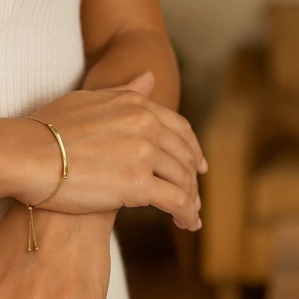 14k yellow gold lariat bracelet featuring a polished curved bar in a modern design, perfect for elegant layering.
