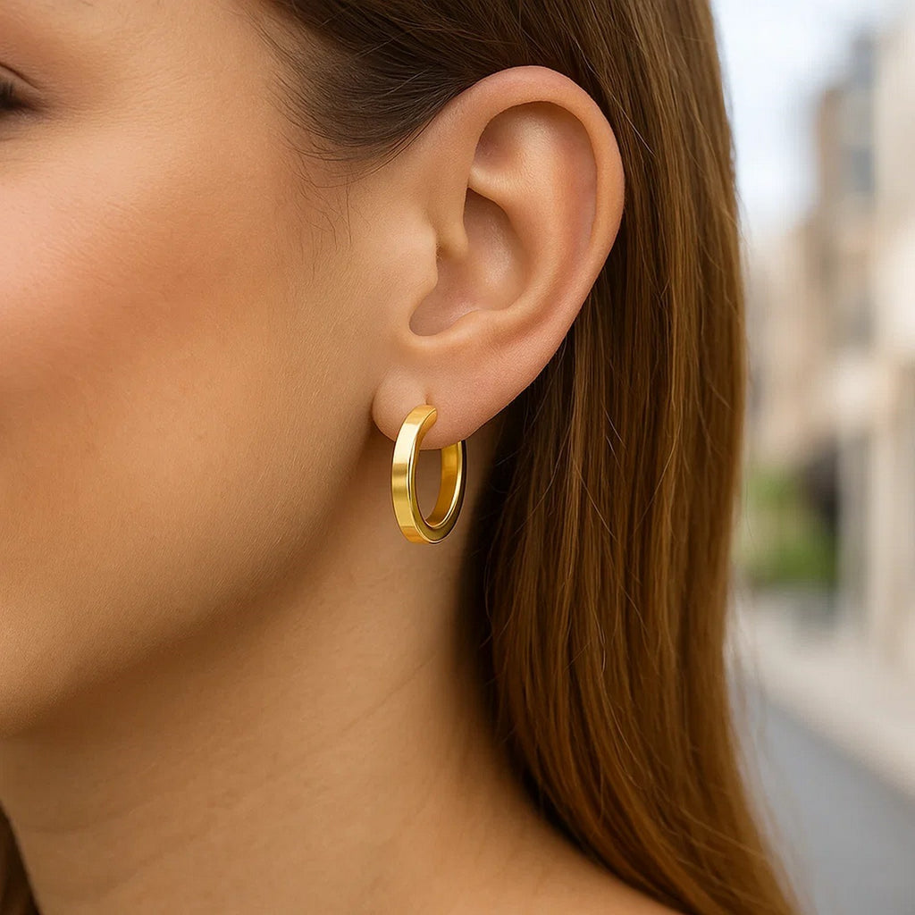 14K yellow gold polished hoop earrings with a modern design, perfect for elegant everyday wear.