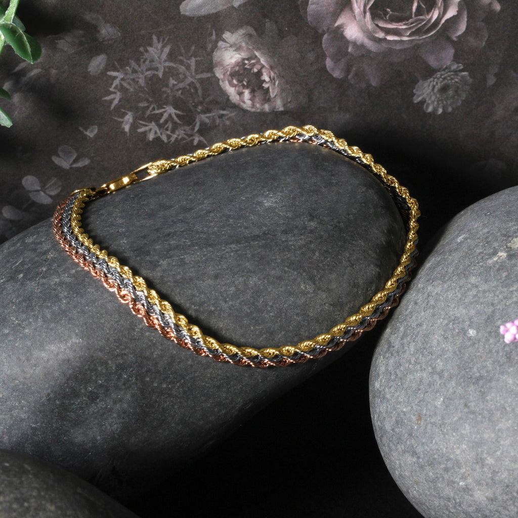 Tri-toned 10k gold multi-strand rope chain bracelet featuring modern design and luxurious 14k gold craftsmanship.