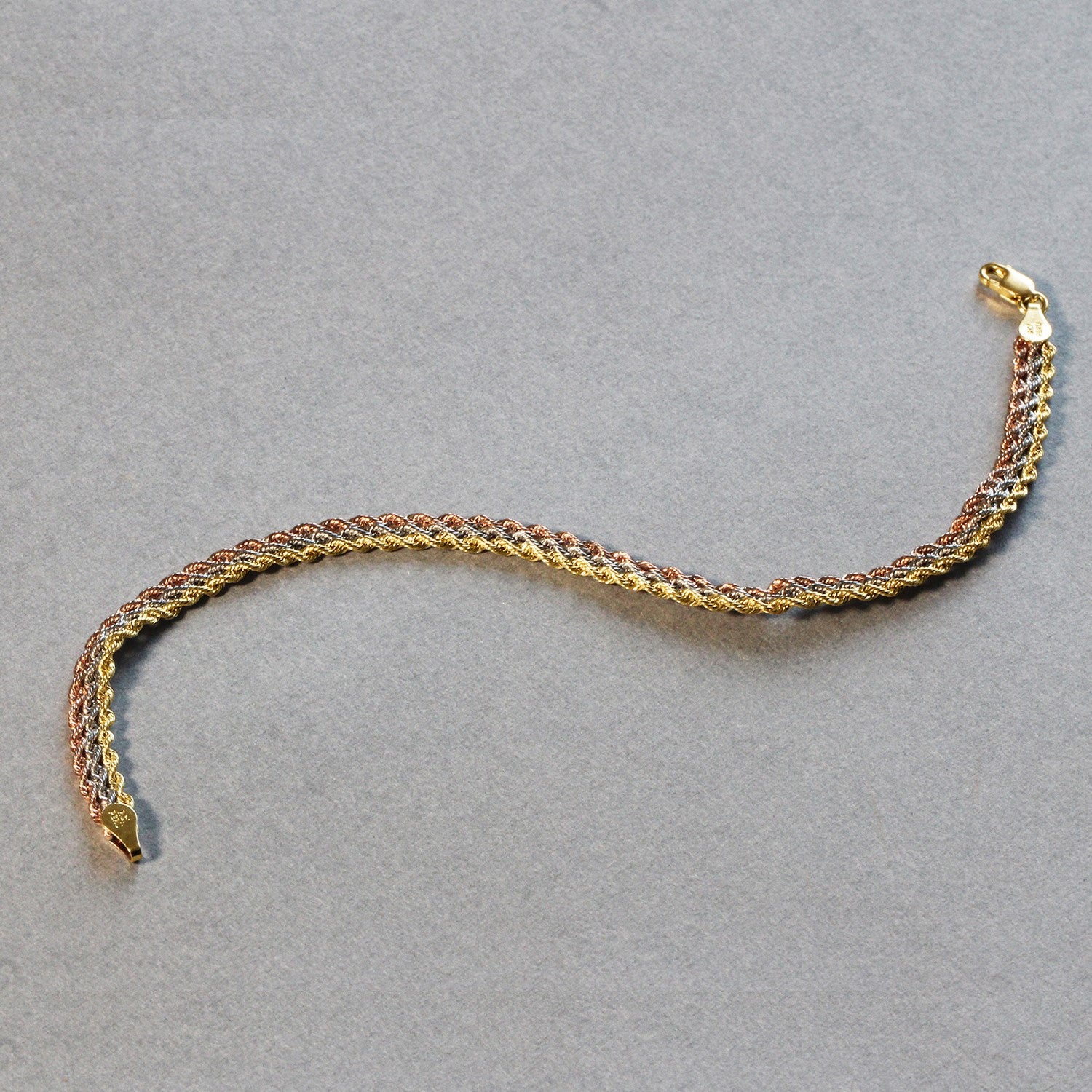 10k tri-toned gold multi-strand rope chain bracelet in 14k gold, showcasing a modern design and luxurious elegance.