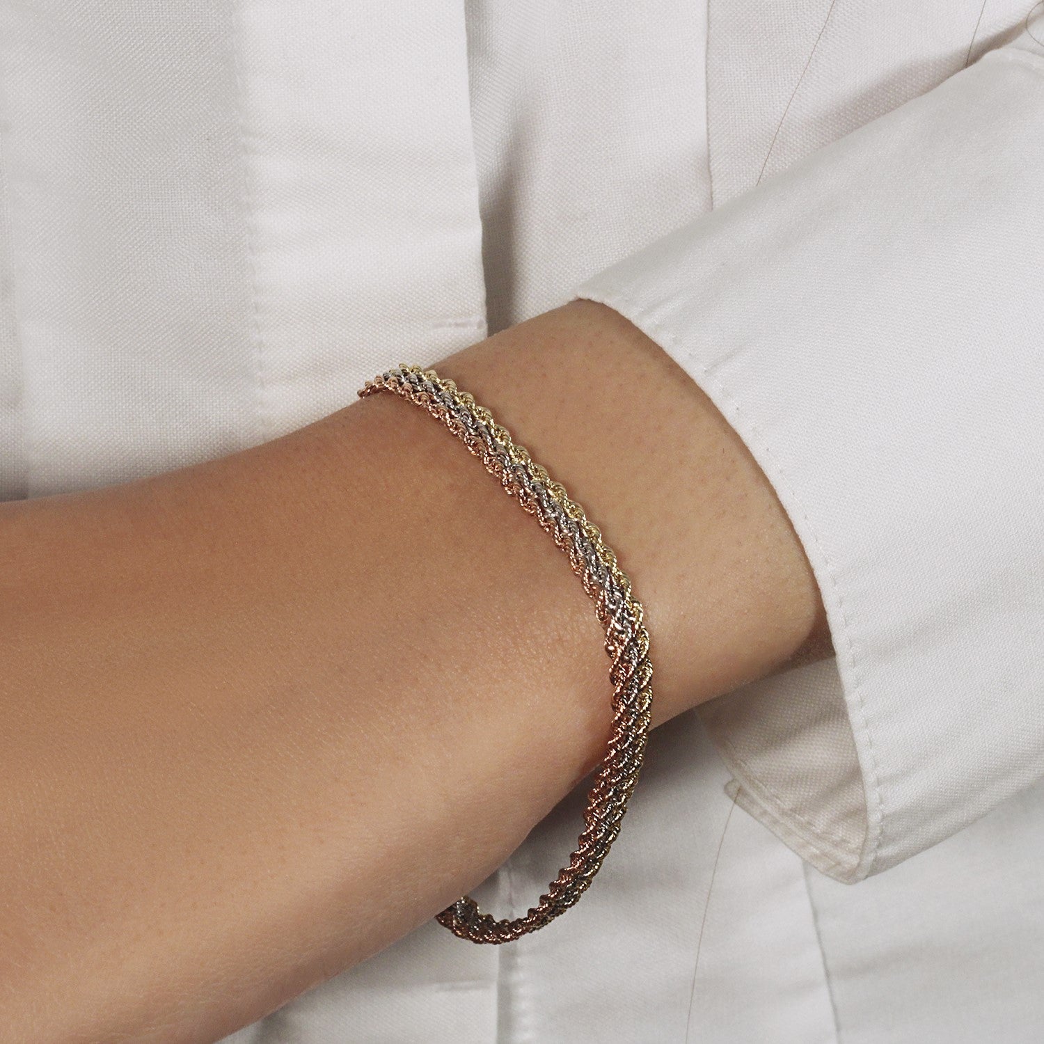 10k tri-toned gold multi-strand rope chain bracelet in modern design, crafted from luxurious 14k gold.