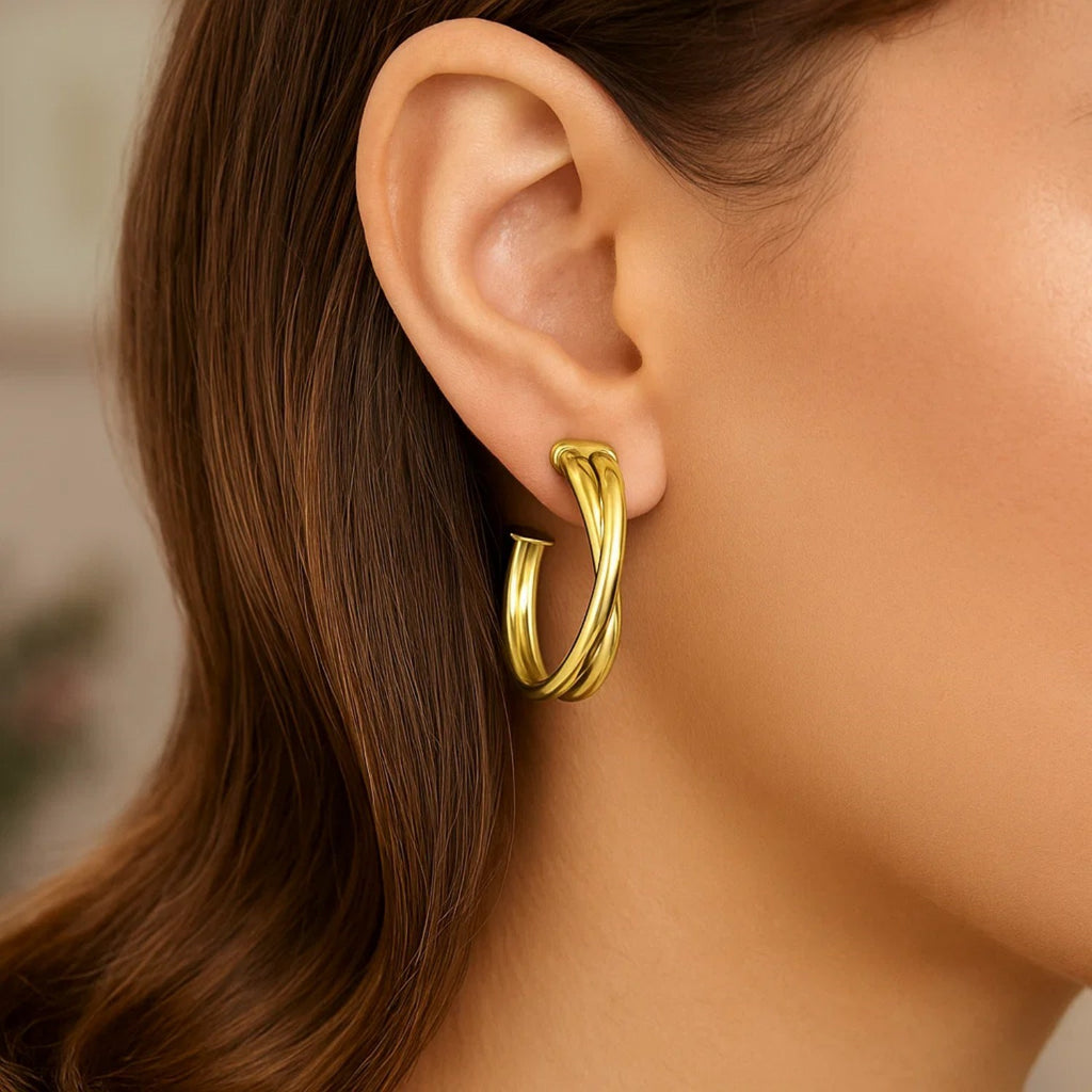 14k yellow gold textured crossover hoop earrings, showcasing a minimalist design with elegant curves and refined finish.