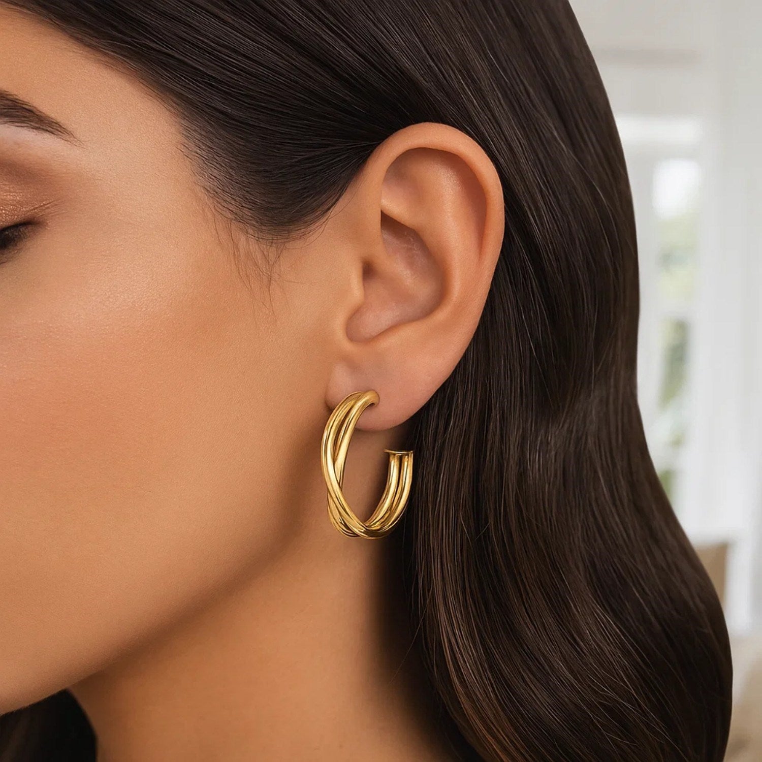 14k yellow gold textured crossover hoop earrings exuding minimalist elegance and refined luxury.