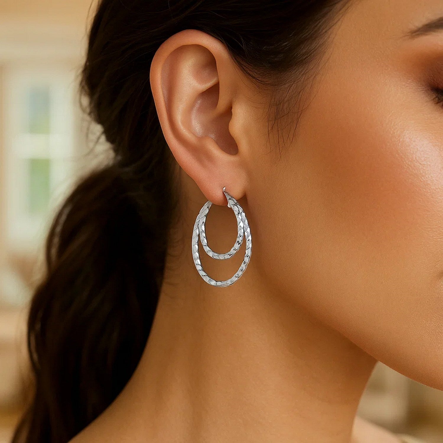 Sterling silver textured double oval hoop earrings showcasing modern elegance and refined craftsmanship.