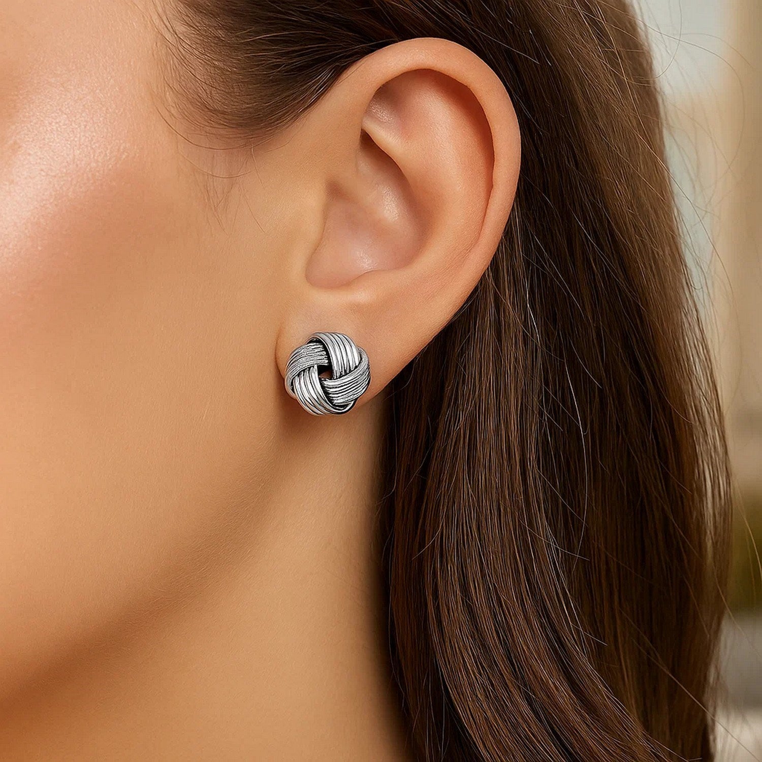 Sterling silver textured groove love knot earrings, elegantly designed for a luxurious touch.