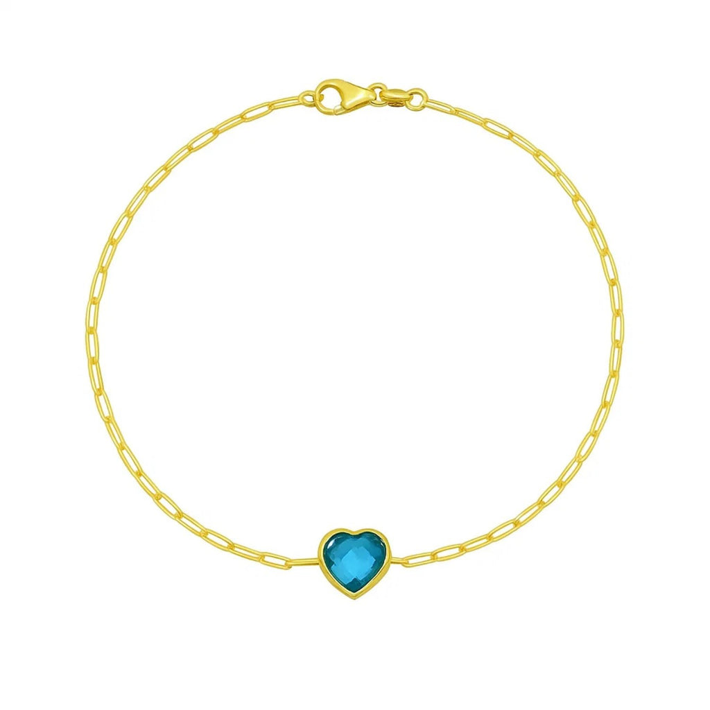 14k yellow gold bracelet featuring a heart-shaped blue topaz in a modern bezel setting, perfect for elegant occasions.