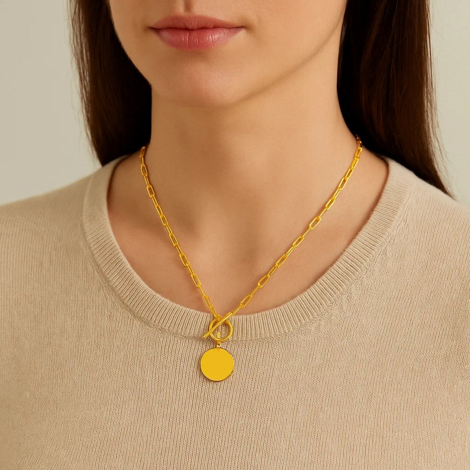 14k yellow gold paperclip chain necklace featuring a modern circle pendant with a sleek, elegant design.