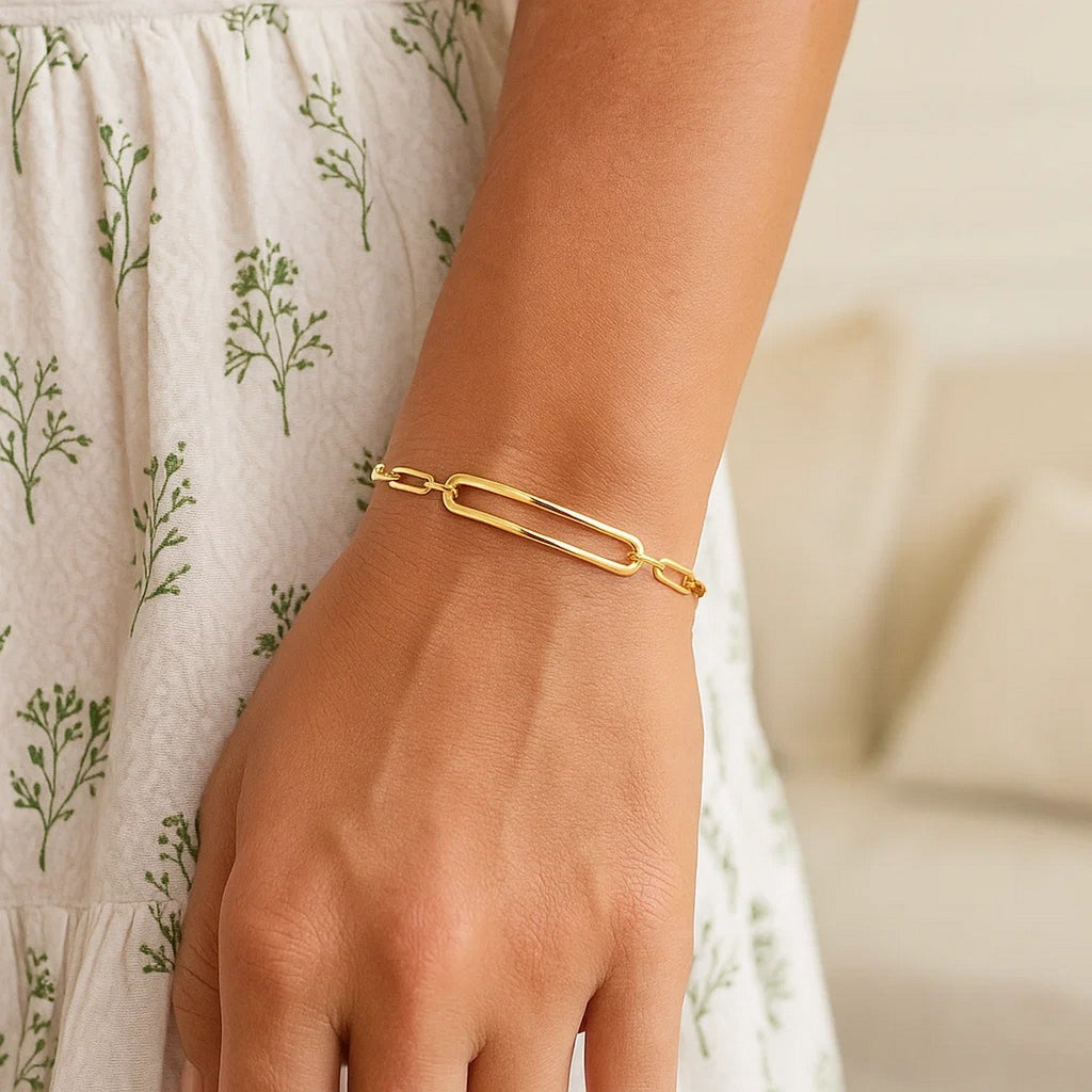 14k yellow gold high polish open curved paperclip bracelet, modern design with elegant link detailing.