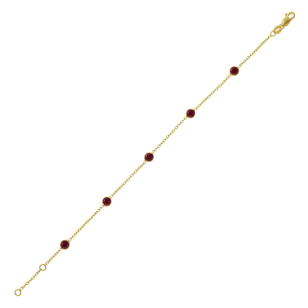 14k yellow gold ruby station bracelet featuring modern bezel settings and an elegant chain design.