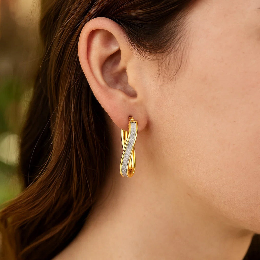 14k two-tone gold glittery oval hoop earrings with a modern design, perfect for elevating any luxury jewelry collection.