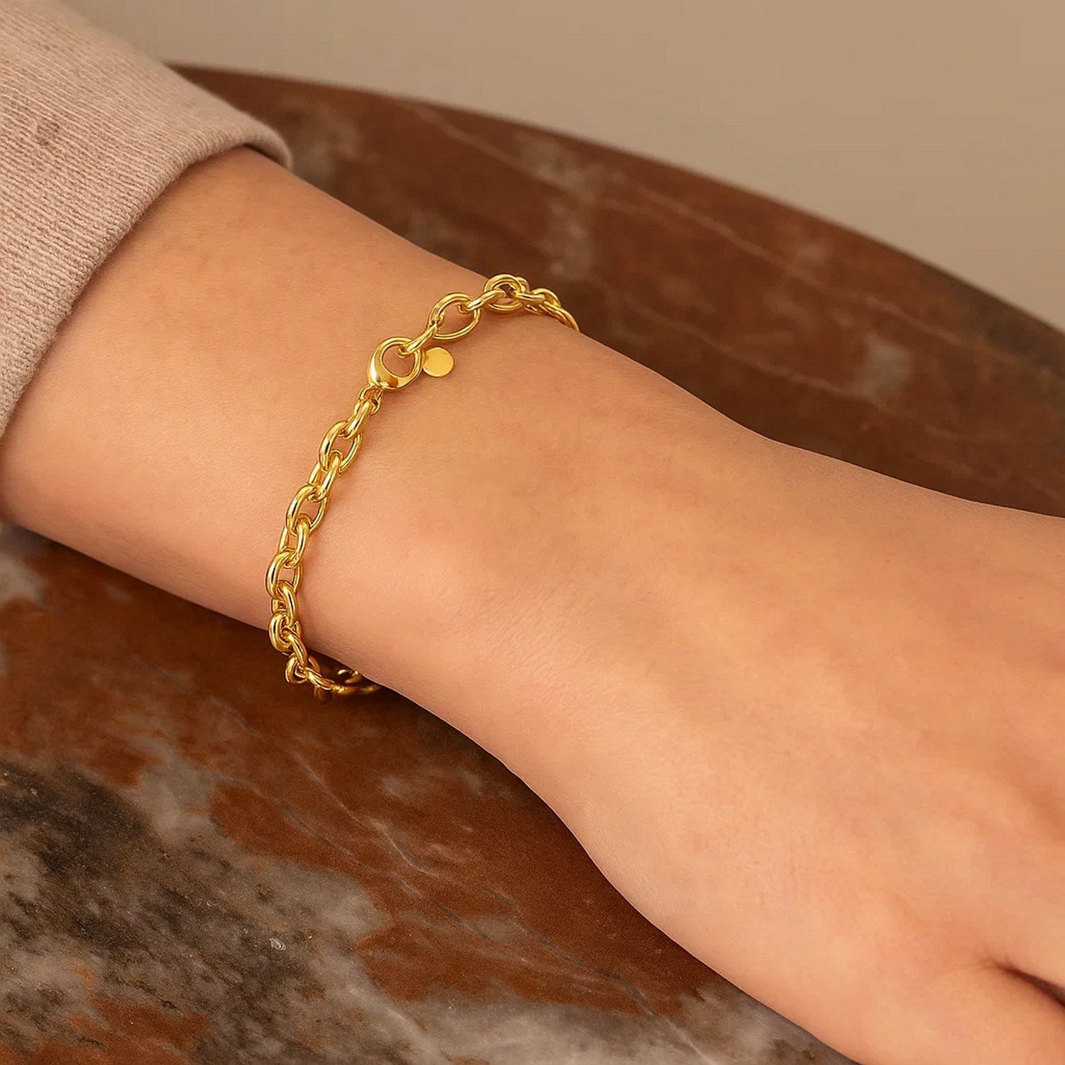 14K yellow gold charm lock rolo chain bracelet with modern link design, showcasing elegance and luxury craftsmanship.