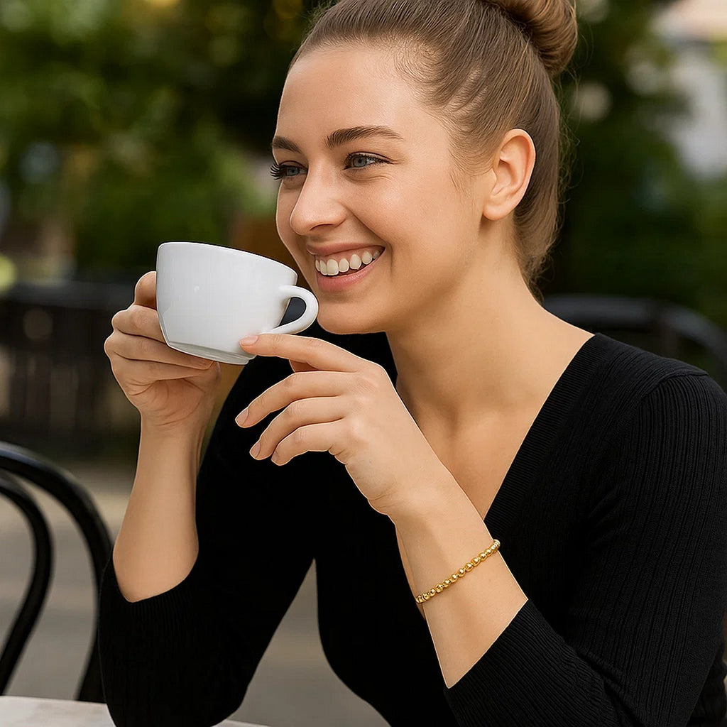 14k yellow gold bead bracelet featuring modern design and stud accents, perfect for elegant layering or solo wear.