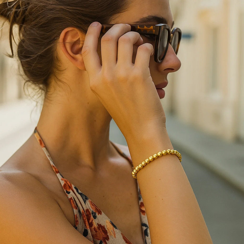 14k yellow gold bead bracelet featuring modern design with elegant stud accents, perfect for luxury styling.