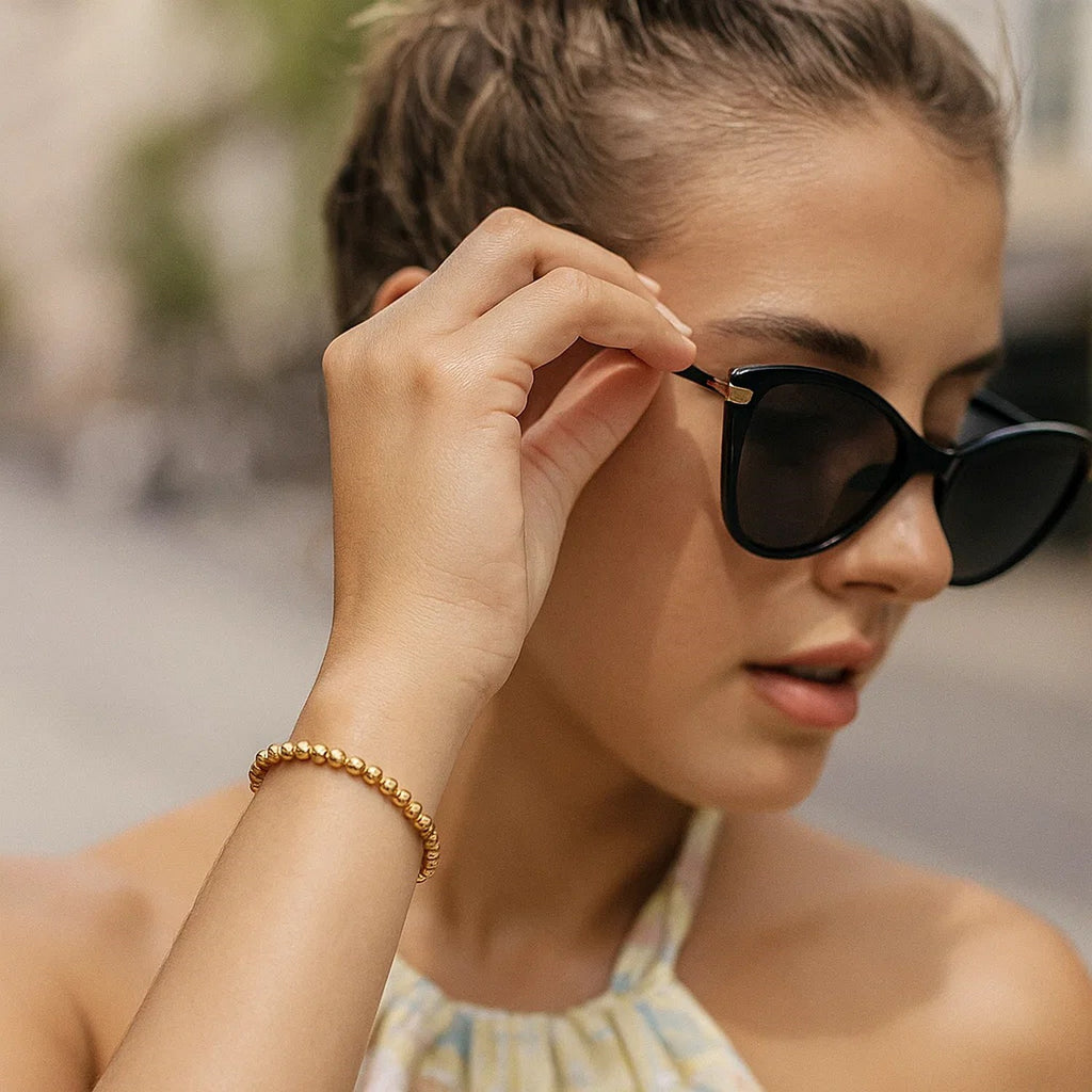 14k yellow gold bead bracelet featuring modern design and elegant stud accents, perfect for sophisticated styling.