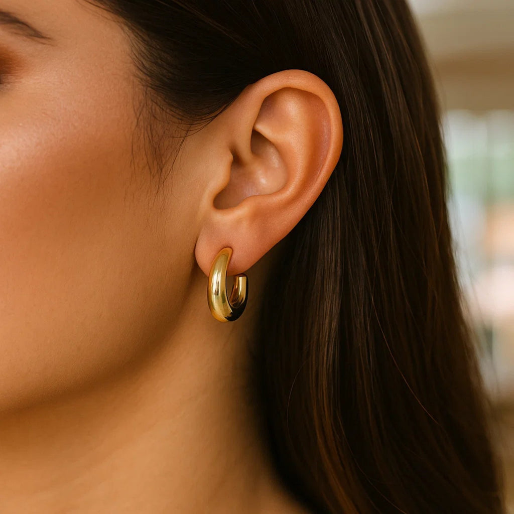 14k yellow gold polished hoop earrings with a sleek modern design, perfect for elegant everyday wear.