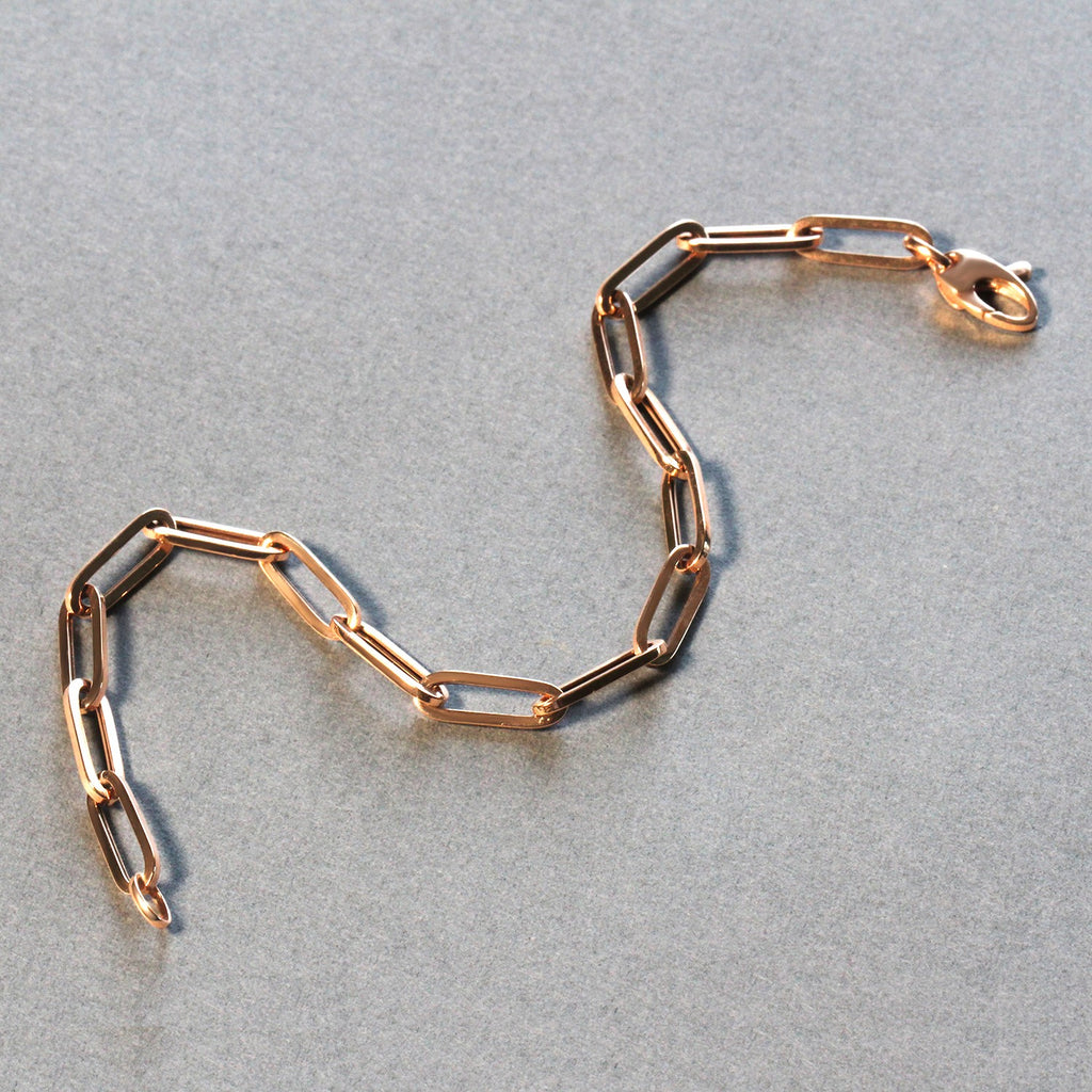 14K rose gold bold paperclip chain bracelet featuring modern links, perfect for elegant layering or standalone wear.
