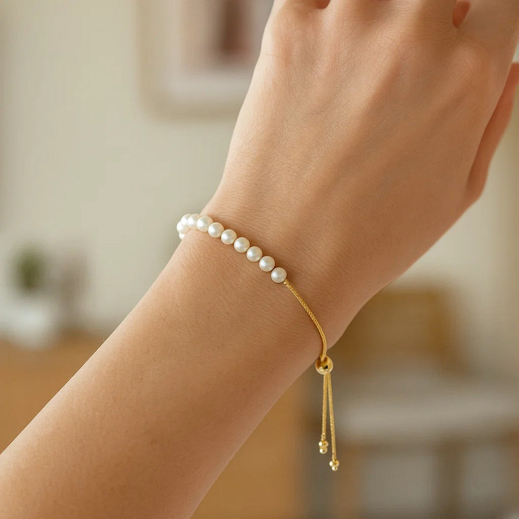 14k yellow gold adjustable friendship bracelet adorned with elegant round pearls in a modern design