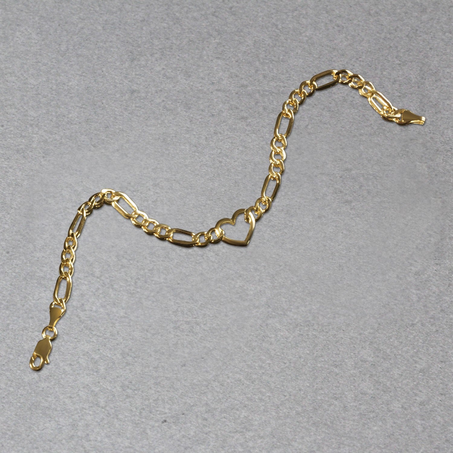 14k yellow gold 7-inch Figaro chain bracelet featuring elegant heart links in a contemporary design.