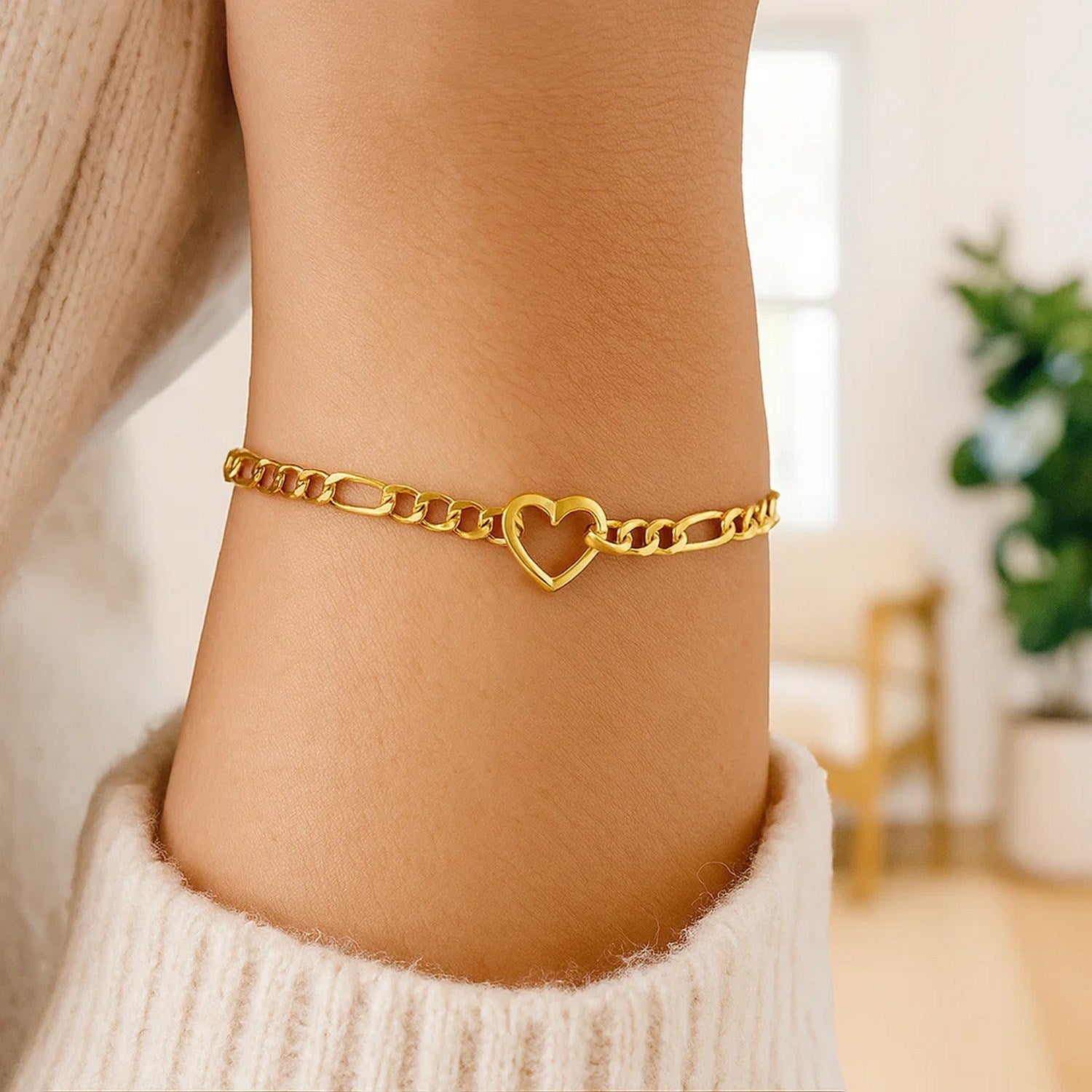 14k yellow gold 7-inch Figaro chain bracelet featuring a heart link design, perfect for contemporary elegance.