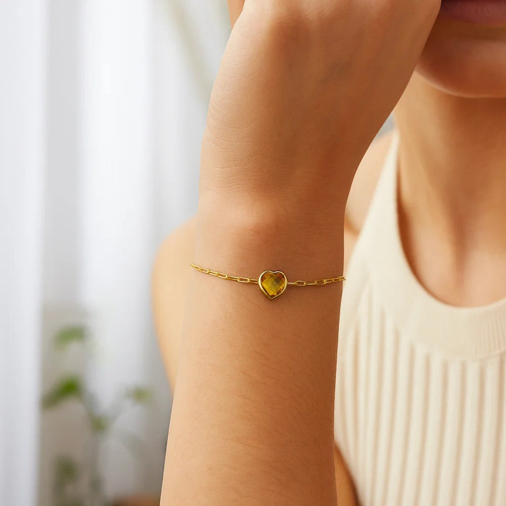 14k yellow gold bracelet featuring a heart-shaped citrine in a refined bezel setting, perfect for elegant occasions.