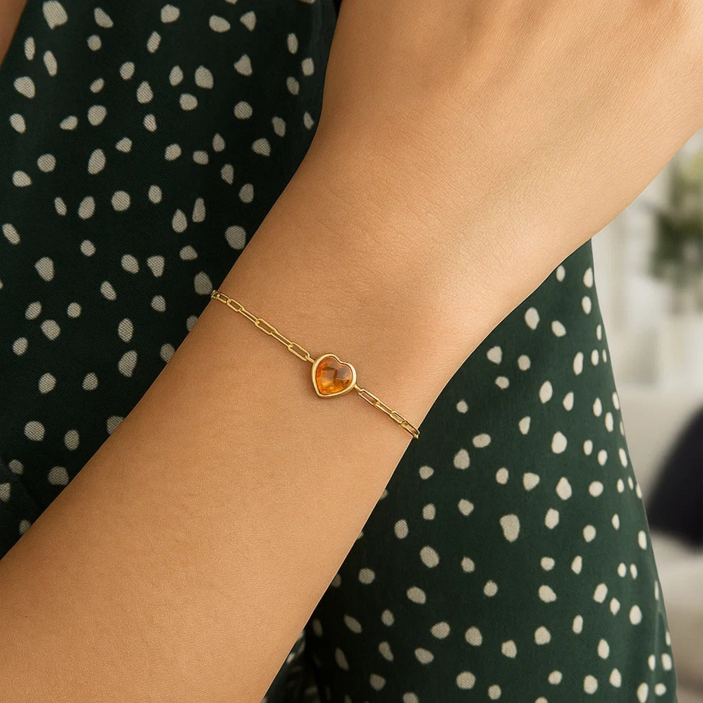 14k yellow gold bracelet featuring a heart-shaped citrine in a refined bezel setting, exuding elegant charm.