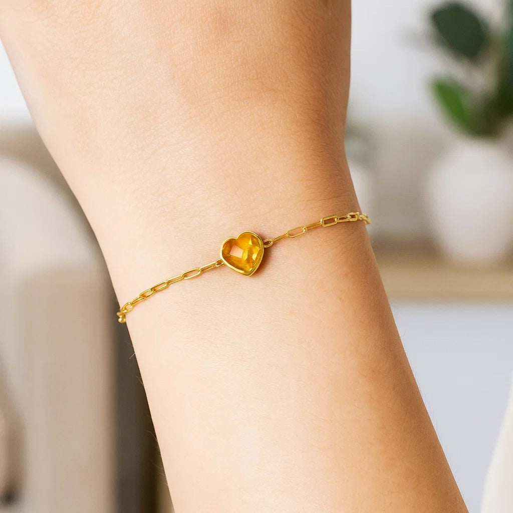 14k yellow gold bracelet featuring a heart-shaped citrine in a refined bezel setting, perfect for elegant occasions.