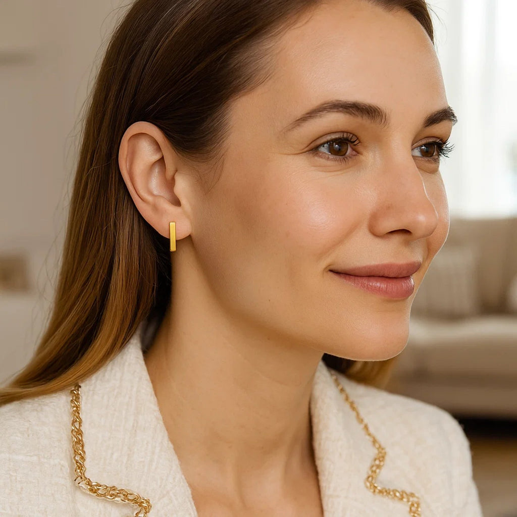 14k yellow gold bar post earrings with a sleek modern design, perfect for adding luxury to any outfit.