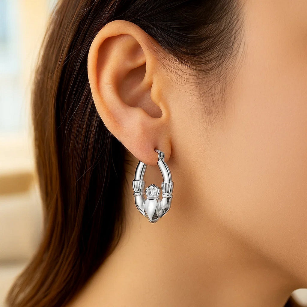 Polished 14k white gold hoop earrings featuring a modern Claddagh design, perfect for elegant occasions.