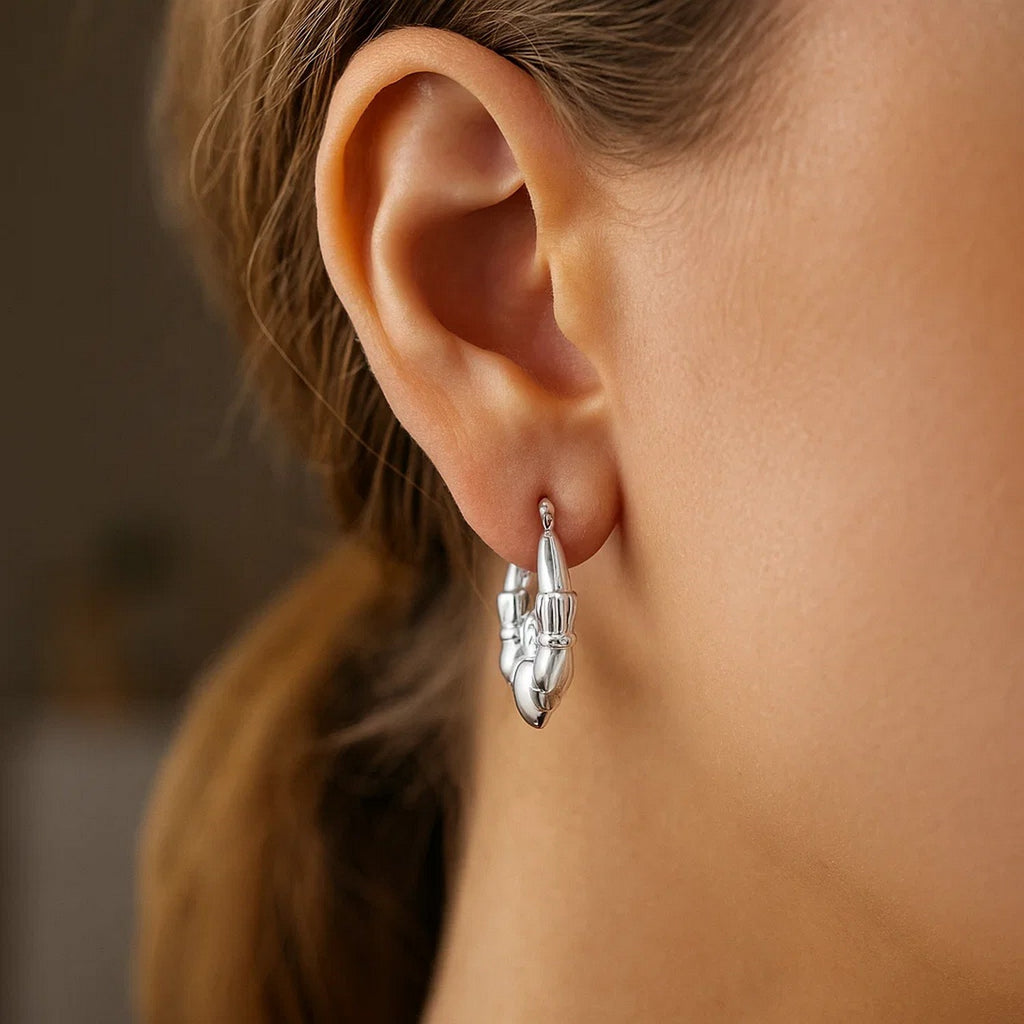 14k white gold polished Claddagh hoop earrings featuring a modern design and elegant craftsmanship.