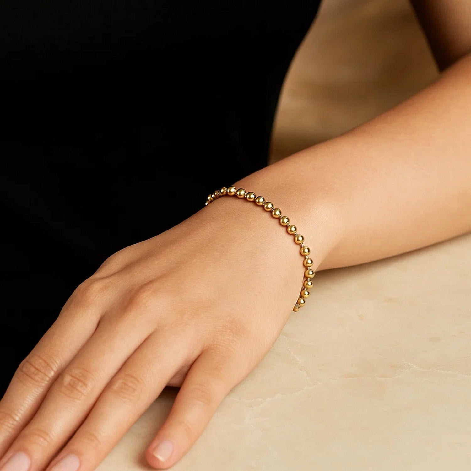 Contemporary 14k yellow gold moon cut bead chain bracelet, showcasing elegant round beads and a refined design.