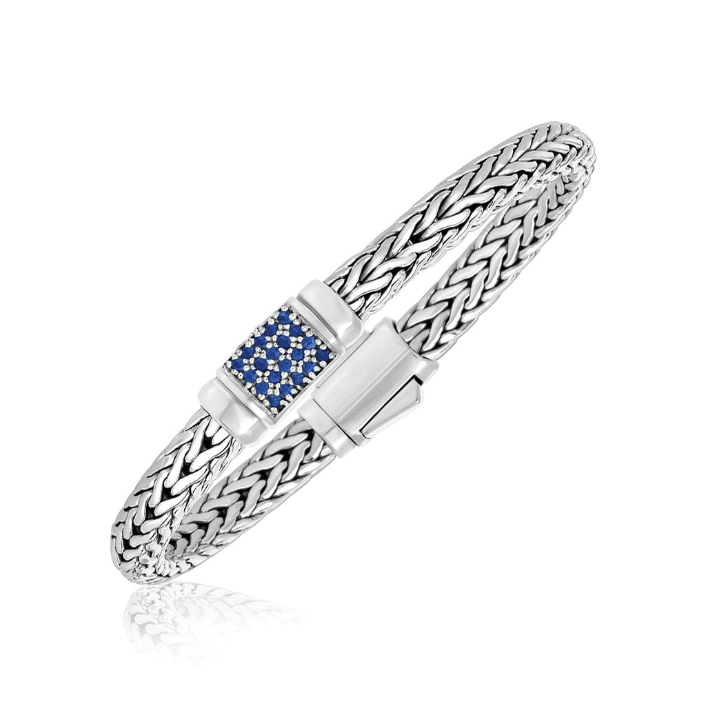Sterling silver weave motif bracelet adorned with blue sapphire embellishments, showcasing modern luxury design.